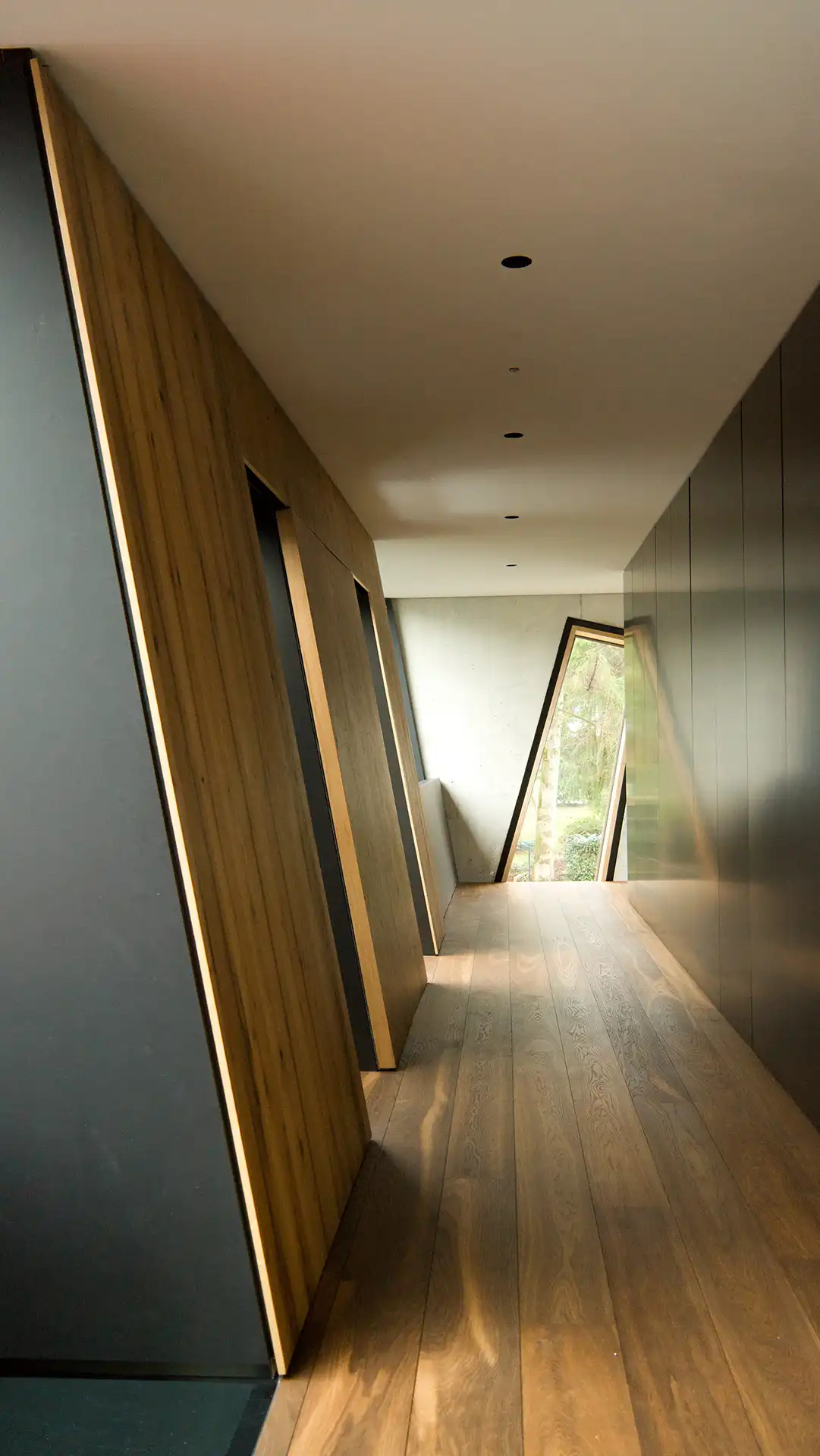 Flur in der Villa im Hardtwald mit geneigter Wand aus Balkeneiche